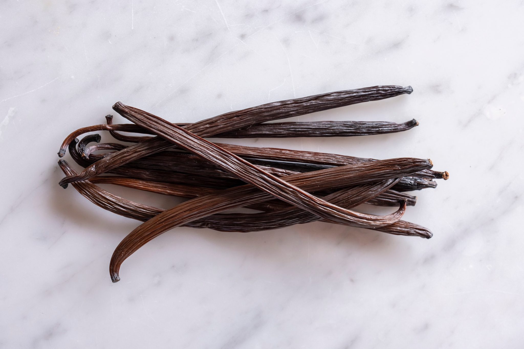 Grade A vanilla pods on a light surface
